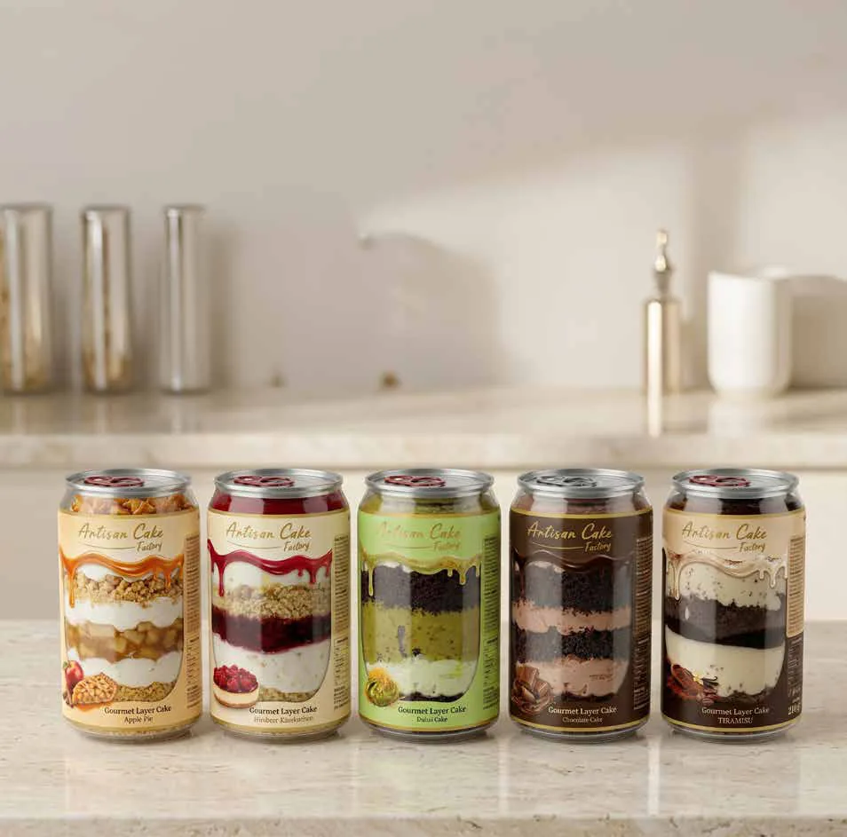Close-up of the cans – layers of sponge, cream and fruit visible through the wall